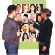 A social worker standing with another person. They are looking at photographs of lots of different people, and both pointing to one of the people.