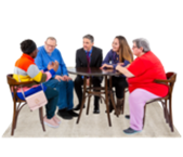 A group of people sitting around a table talking