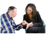 A social worker explaining something on a piece of paper to another person.