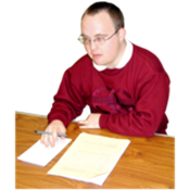 A person sitting at a desk making some notes.