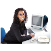 A social care worker at a desk with a computer and a telephone