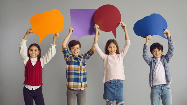 Image showing children holding up coloured speech bubbles