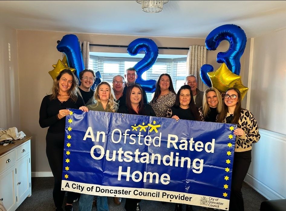 Cromwell Drive team are holding outstanding banner and celebrating success. 